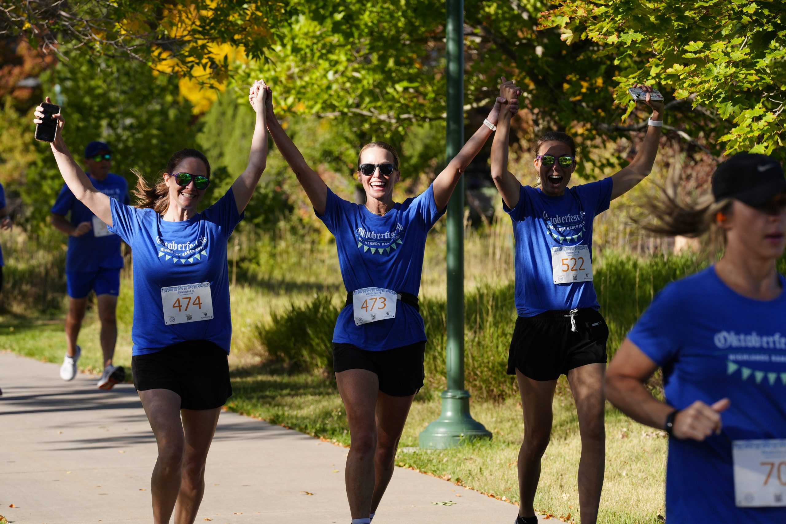 women smiling while running a race