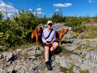 woman sitting outside with dog
