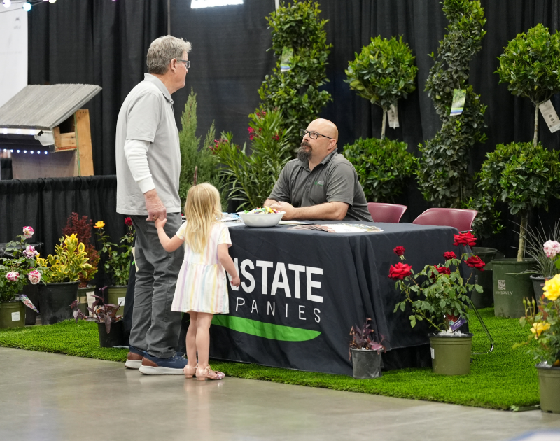 man talking to attendees at home show