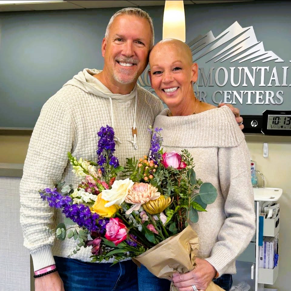 man and woman holding flowers