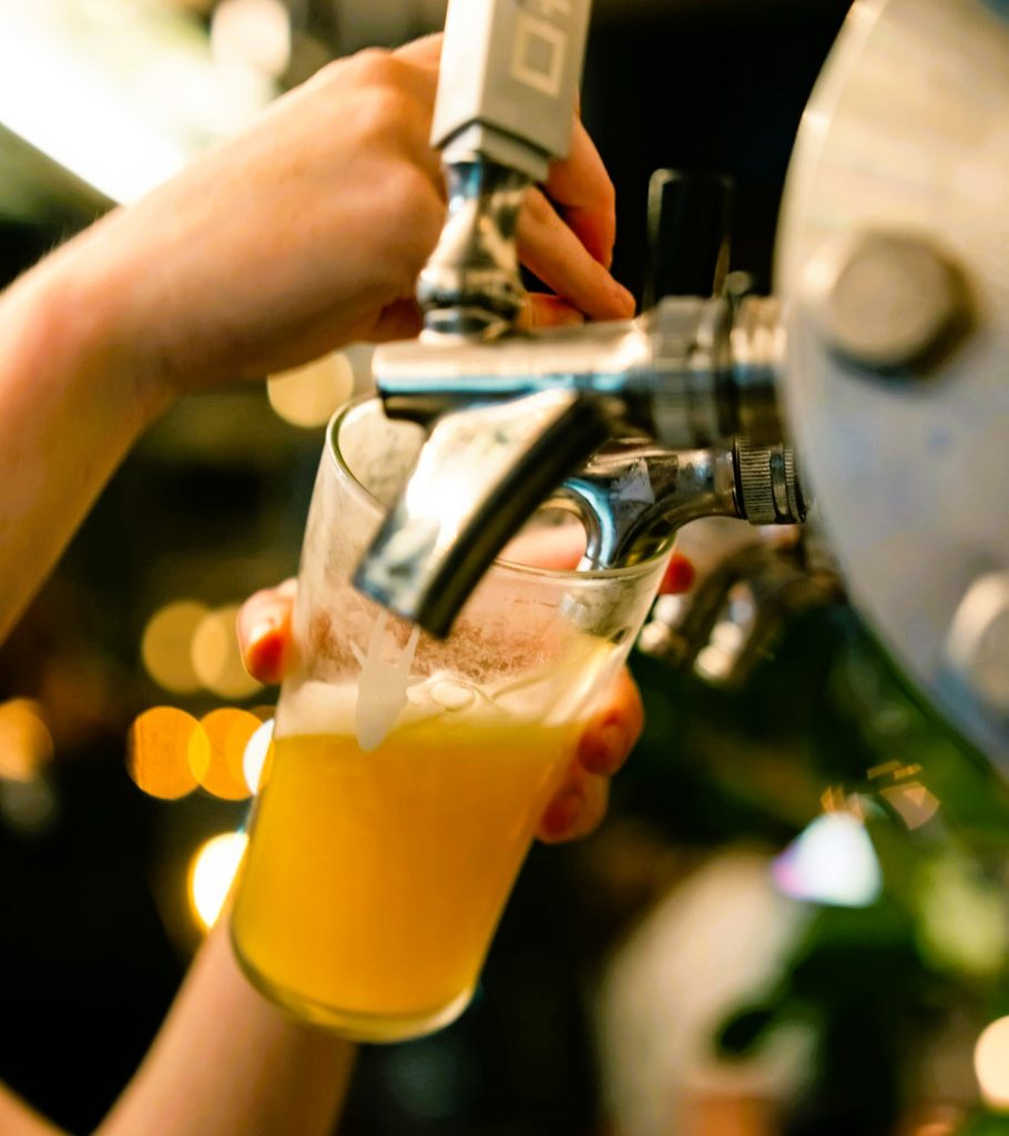close up on hand pouring beer