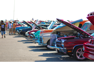 people walking at a car show