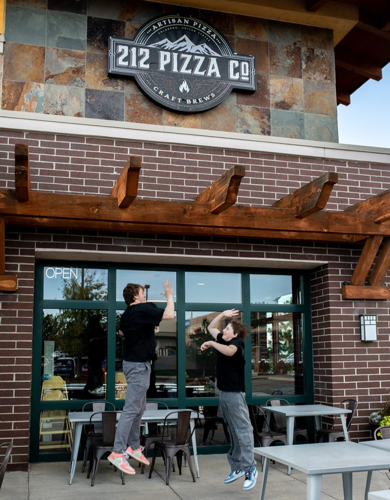 sign in front of pizza restaurant