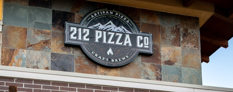 sign in front of 212 Pizza Co